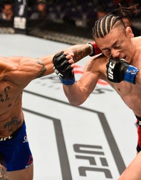 SALT LAKE CITY, UT - AUGUST 06:  (L-R) Cub Swanson punches Tatsuya Kawajiri of Japan in their featherweight bout during the UFC Fight Night event at Vivint Smart Home Arena on August 6, 2016 in Salt Lake City, Utah. (Photo by Jeff Bottari/Zuffa LLC/Zuffa 