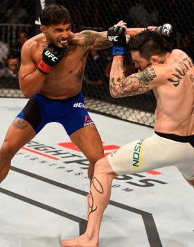 SALT LAKE CITY, UT - AUGUST 06:  (L-R) Dennis Bermudez punches Rony Jason of Brazil in their featherweight bout during the UFC Fight Night event at Vivint Smart Home Arena on August 6, 2016 in Salt Lake City, Utah. (Photo by Jeff Bottari/Zuffa LLC/Zuffa L