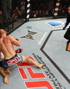 LAS VEGAS, NV - JUNE 01:   Martin Kampmann (blue shorts) attempts to finish Jake Ellenberger as referee Steve Mazzagatti (right) observes in a Welterweight bout during The Ultimate Fighter Live Finale at the Pearl Theater at the Palms Casino Resort on Jun