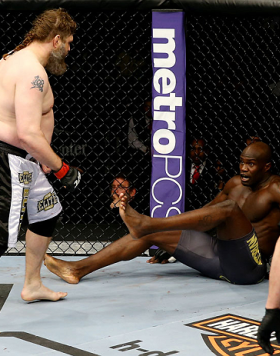 NEWARK, NJ - APRIL 27:  Cheick Kongo (R) of France sits against the cage as Roy Nelson (L) approaches in their heavyweight bout during the UFC 159 event at the Prudential Center on April 27, 2013 in Newark, New Jersey.  (Photo by Al Bello/Zuffa LLC/Zuffa 