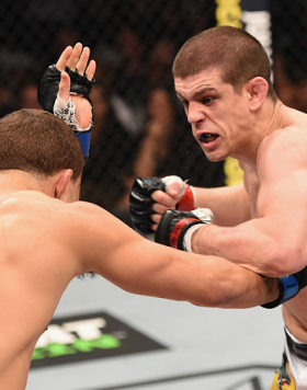 LAS VEGAS, NV - JANUARY 31:  (R-L) Joe Lauzon punches Al Iaquinta in their lightweight bout during the UFC 183 event at the MGM Grand Garden Arena on January 31, 2015 in Las Vegas, Nevada.  (Photo by Josh Hedges/Zuffa LLC/Zuffa LLC via Getty Images) *** L