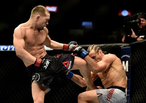 Petr Yan of Russia knees Urijah Faber in their bantamweight bout during the UFC 245 event at T-Mobile Arena on December 14, 2019 in Las Vegas, Nevada. (Photo by Chris Unger/Zuffa LLC)
