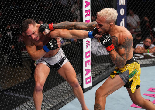 Charles Oliveira punches Michael Chandler in their UFC lightweight championship bout at Toyota Center on May 15, 2021 in Houston, Texas. (Photo by Josh Hedges/Zuffa LLC)