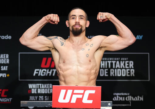 Robert Whittaker poses on the scale during the UFC Fight Night official weigh-ins