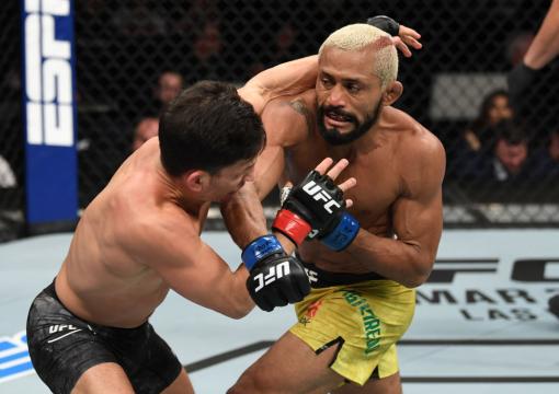NORFOLK, VA - FEBRUARY 29: (R-L) Deiveson Figueiredo punches Joseph Benavidez in their flyweight championship bout during the UFC Fight Night 