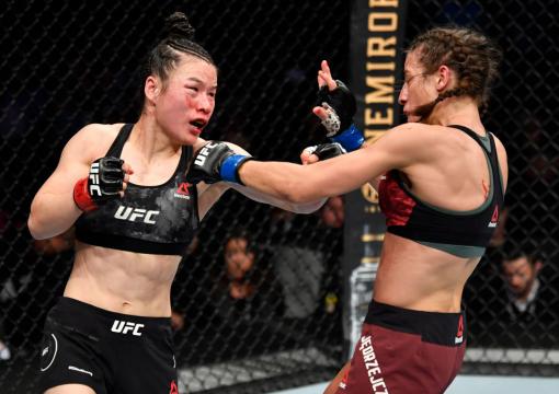 LAS VEGAS, NEVADA - MARCH 07: (L-R) Zhang Weili of China punches Joanna Jedrzejczyk of Poland in their UFC strawweight championship fight during the UFC 248 