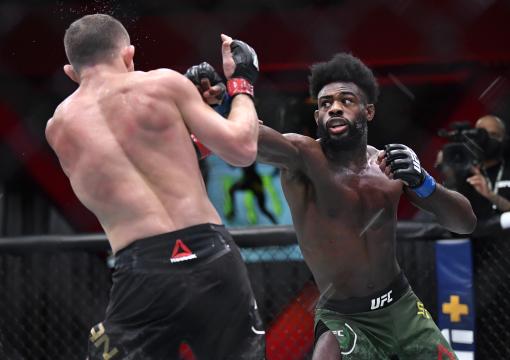 LAS VEGAS, NEVADA - MARCH 06: (R-L) Aljamain Sterling punches Petr Yan of Russia in their UFC bantamweight championship fight during the UFC 259