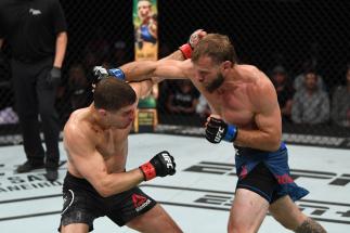 OTTAWA, ON - MAY 04: (R-L) Donald Cerrone punches Al Iaquinta in their lightweight bout during the UFC Fight Night event at Canadian Tire Centre on May 4, 2019 in Ottawa, Ontario, Canada. (Photo by Jeff Bottari/Zuffa LLC/Zuffa LLC via Getty Images)
