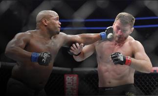 Daniel Cormier (L) lands a punch against Stipe Miocic during their heavyweight championship fight at T-Mobile Arena on July 7, 2018 in Las Vegas, Nevada. Cormier won by first round knockout. (Photo by Sam Wasson/Getty Images)