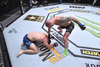 Sasha Palatnikov punches Louis Cosce in their welterweight bout during the UFC 255 event at UFC APEX on November 21, 2020 in Las Vegas, Nevada. (Photo by Jeff Bottari/Zuffa LLC)