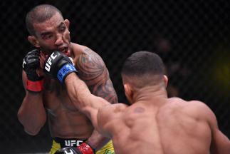 Khalid Taha of Germany punches Raoni Barcelos of Brazil in a bantamweight fight during the UFC Fight Night event at UFC APEX on November 07, 2020 in Las Vegas, Nevada. (Photo by Jeff Bottari/Zuffa LLC)