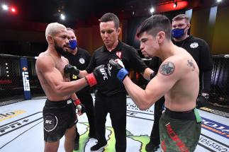 Deiveson Figueiredo of Brazil and Brandon Moreno of Mexico touch gloves prior to their flyweight championship bout during the UFC 256 event at UFC APEX on December 12, 2020 in Las Vegas, Nevada. (Photo by Jeff Bottari/Zuffa LLC)