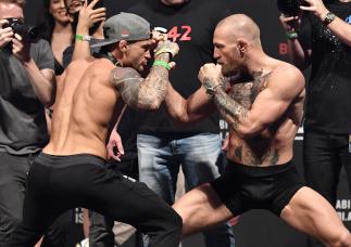 Dustin Poirier and Conor McGregor of Ireland face off during the UFC 257 weigh-in at Etihad Arena on UFC Fight Island on January 22, 2021 in Abu Dhabi, United Arab Emirates. (Photo by Jeff Bottari/Zuffa LLC)
