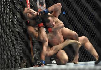 Umar Nurmagomedov of Russia secures a rear choke submission against Sergey Morozov of Kazakhstan in a bantamweight fight during the UFC Fight Night event at Etihad Arena on UFC Fight Island on January 20, 2021 in Abu Dhabi, United Arab Emirates