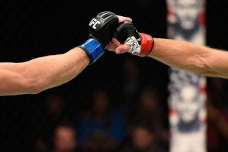 Zak Ottow and Joshua Burkman touch gloves in their welterweight bout during the UFC Fight Night event at the Moda Center on October 1, 2016 in Portland, Oregon. (Photo by Josh Hedges/Zuffa LLC)