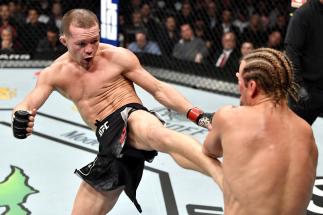 Petr Yan of Russia kicks Urijah Faber in their bantamweight bout during the UFC 245 event at T-Mobile Arena on December 14, 2019 in Las Vegas, Nevada. (Photo by Jeff Bottari/Zuffa LLC)