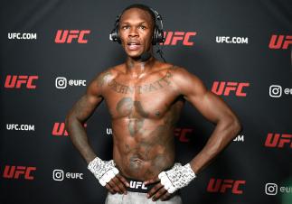 UFC Middleweight Champion Israel Adesanya reacts with Joe Rogan After His Light Heavyweight Title Shot Loss to Jan Blachowicz at UFC 259 on March 6, 2021.