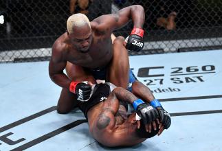 Derek Brunson punches Kevin Holland in their middleweight fight during the UFC Fight Night event at UFC APEX on March 20, 2021 in Las Vegas, Nevada. (Photo by Chris Unger/Zuffa LLC)