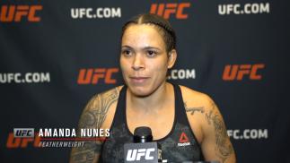 UFC women's featherweight champion Amanda Nunes reacts with UFC.com after her first-round submission victory over Megan Anderson at UFC 259: Blachowicz vs Adesanya on March 6, 2021