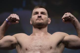 Stipe Miocic poses on the scale during the UFC 211 weigh-in at the American Airlines Center on May 12, 2017 in Dallas, Texas. (Photo by Cooper Neill/Zuffa LLC/Zuffa LLC via Getty Images)