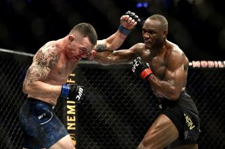Kamaru Usman of Nigeria punches Colby Covington in their UFC welterweight championship bout during the UFC 245 event at T-Mobile Arena on December 14, 2019 in Las Vegas, Nevada. (Photo by Chris Unger/Zuffa LLC)