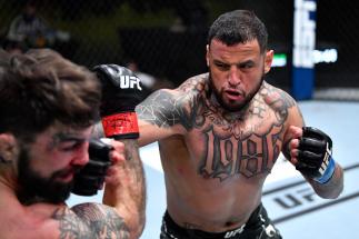 Daniel Rodriguez punches Mike Perry in a welterweight fight during the UFC Fight Night event at UFC APEX on April 10, 2021 in Las Vegas, Nevada. (Photo by Chris Unger/Zuffa LLC)