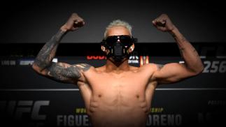 Charles Oliveira of Brazil poses on the scale during the UFC 256 weigh-in at UFC APEX on December 11, 2020 in Las Vegas, Nevada. (Photo by Jeff Bottari/Zuffa LLC via Getty Images)