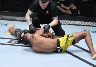 Carlston Harris secures a choke submission against Christian Aguilera in a welterweight fight during the UFC Fight Night event at UFC APEX on May 08, 2021 in Las Vegas, Nevada. (Photo by Chris Unger/Zuffa LLC)
