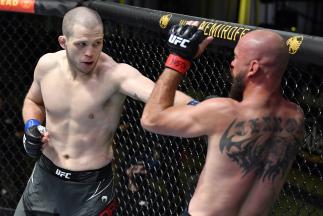 Alex Morono punches Donald 'Cowboy' Cerrone in a welterweight fight during the UFC Fight Night event at UFC APEX on May 08, 2021 in Las Vegas, Nevada. (Photo by Chris Unger/Zuffa LLC)