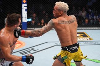 Charles Oliveira of Brazil punches Michael Chandler in their UFC lightweight championship bout at Toyota Center on May 15, 2021 in Houston, Texas. (Photo by Josh Hedges/Zuffa LLC)