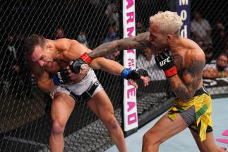 Charles Oliveira of Brazil punches Michael Chandler in their UFC lightweight championship bout at Toyota Center on May 15, 2021 in Houston, Texas. (Photo by Josh Hedges/Zuffa LLC)
