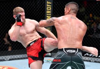Marcin Prachnio of Poland kicks the body of Ike Villanueva in a light heavyweight fight during the UFC Fight Night event at UFC APEX on June 26, 2021 in Las Vegas, Nevada. (Photo by Chris Unger/Zuffa LLC)