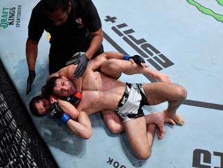 Islam Makhachev of Russia secures a rear choke submission against Thiago Moises of Brazil in their lightweight bout during the UFC Fight Night event at UFC APEX on July 17, 2021 in Las Vegas, Nevada. (Photo by Jeff Bottari/Zuffa LLC)