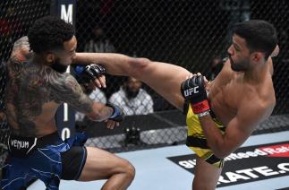 Julio Arce kicks Andre Ewell in their bantamweight fight