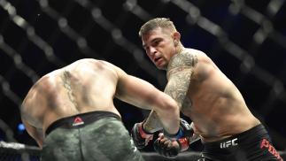 Dustin Poirier punches Conor McGregor of Ireland in a lightweight fight during the UFC 257 event inside Etihad Arena on UFC Fight Island on January 23 2021 in Abu Dhabi United Arab Emirates (Photo by Chris Unger/Zuffa LLC)