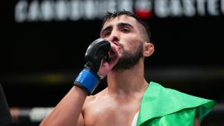 Saidyokub Kakhramonov of Uzbekistan reacts after his third-round technical submission over Trevin Jones of Guam in their bantamweight bout at UFC Fight Night: Cannonier vs Gastelum on August 21 2021 in Las Vegas Nevada (Photo by Chris Unger/Zuffa LLC)