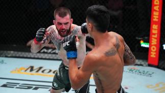 Austin Lingo punches Luis Salaña in their featherweight matchup at UFC Fight Night: Cannonier vs Gastelum on August 21 2021 in Las Vegas Nevada. (Photo by Chris Unger/Zuffa LLC)