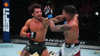 Alexandre Pantoja punches Brandon Royval in their flyweight matchup at UFC Fight Night: Cannonier vs Gastelum on August 21 2021 in Las Vegas Nevada. (Photo by Chris Unger/Zuffa LLC)