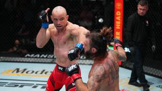 Mark O. Madsen of Denmark punches Clay Guida in their lightweight matchup at UFC Fight Night: Cannonier vs Gastelum on August 21 2021 in Las Vegas Nevada (Photo by Chris Unger/Zuffa LLC)