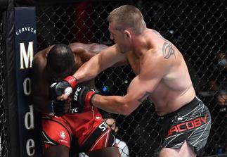 Dustin Jacoby punches Darren Stewart of England in a middleweight fight during the UFC Fight Night event at UFC APEX on August 28 2021 in Las Vegas Nevada. (Photo by Chris Unger/Zuffa LLC)