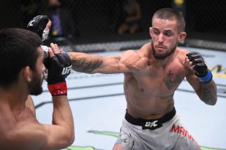 Nate Maness punches Johnny Munoz in their featherweight fight during the UFC Fight Night event at UFC APEX on August 01, 2020 in Las Vegas, Nevada. (Photo by Chris Unger/Zuffa LLC via Getty Images)