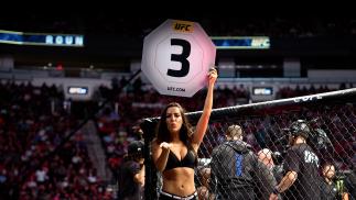 UFC Octagon Girl Luciana Andrade signals the start of round three between Derrick Lewis and Ciryl Gane of France in their interim heavyweight title bout during the UFC 265 event at Toyota Center on August 07, 2021 in Houston, Texas. (Photo by Cooper Neill/Zuffa LLC)