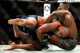 Francis Ngannou of Cameroon (right) tackles Ciryl Gane of France in their heavyweight title fight during the UFC 270 event at Honda Center on January 22, 2022 in Anaheim, California. (Photo by Katelyn Mulcahy/Getty Images)