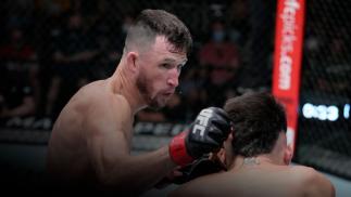 Julian Erosa punches Charles Jourdain of Canada in their fight during the UFC Fight Night event at UFC APEX on September 04, 2021 in Las Vegas, Nevada. (Photo by Jeff Bottari/Zuffa LLC)