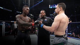 Israel Adesanya of Nigeria and Robert Whittaker of Australia face off as they touch gloves prior to their UFC middleweight championship fight during the UFC 271 event at Toyota Center on February 12, 2022 in Houston, Texas. (Photo by Josh Hedges/Zuffa LLC)