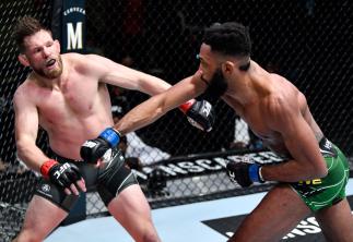 Phil Rowe punches Jason Witt in their welterweight fight during the UFC Fight Night event at UFC APEX on February 05, 2022 in Las Vegas, Nevada. (Photo by Chris Unger/Zuffa LLC)