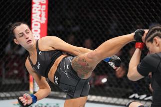 Casey O'Neill of United Kingdom kicks Roxanne Modafferi in their flyweight fight during the UFC 271 event at Toyota Center on February 12, 2022 in Houston, Texas. (Photo by Josh Hedges/Zuffa LLC)