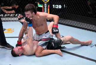 Chad Anheliger punches Jesse Strader in their bantamweight fight during the UFC Fight Night event at UFC APEX on February 19, 2022 in Las Vegas, Nevada. (Photo by Jeff Bottari/Zuffa LLC)
