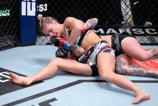 Stephanie Egger of Switzerland punches Jessica-Rose Clark of Australia in their bantamweight fight during the UFC Fight Night event at UFC APEX on February 19, 2022 in Las Vegas, Nevada. (Photo by Jeff Bottari/Zuffa LLC)