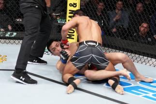 Chris Gutierrez punches Batgerel Danaa of Mongolia in a bantamweight fight during the UFC Fight Night event at Nationwide Arena on March 26, 2022 in Columbus, Ohio. (Photo by Josh Hedges/Zuffa LLC)